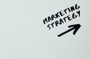 marketing strategies written in black with an arrow underneath it pointing up